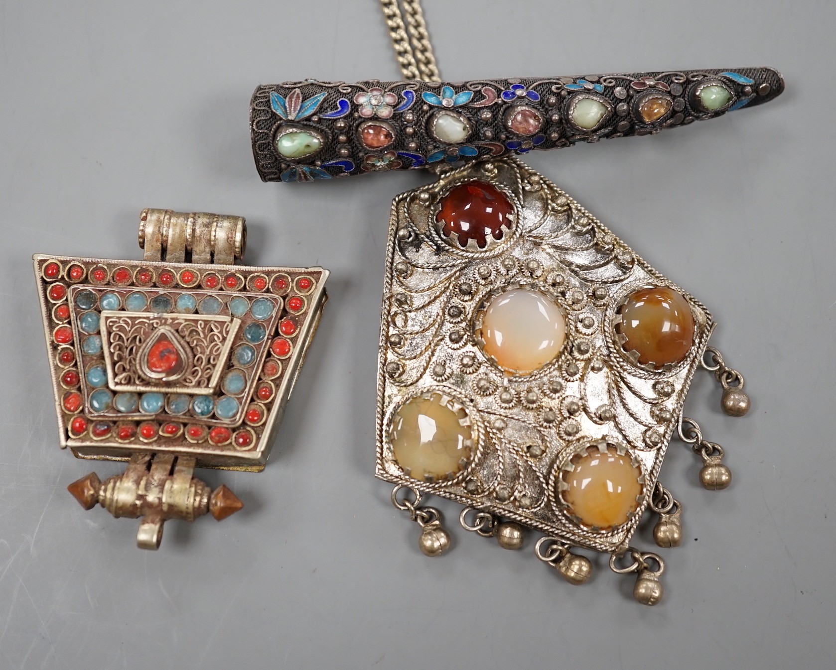 A Chinese filigree white metal, hardstone and enamel set nail guard, 86mm, together with two other Middle Eastern items.